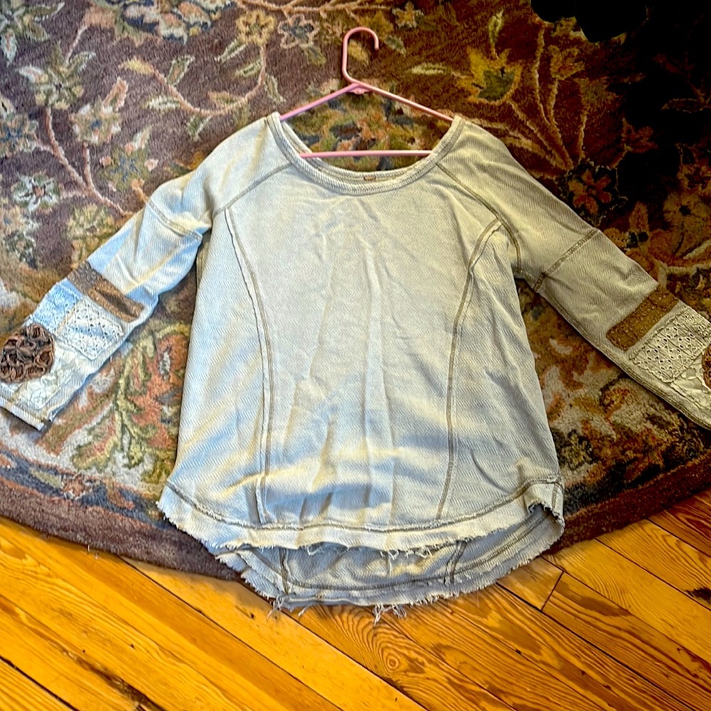 Free people long sleeve shirt/sweater made to look distressed.